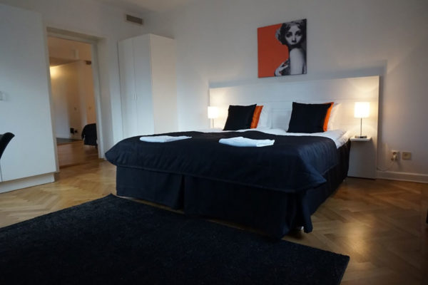Bed in hotel room in Von Dufva Building  one-bedroom apartment